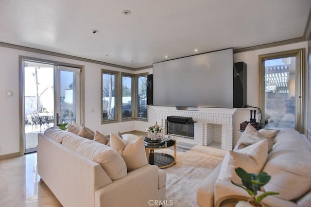 tiled living room featuring a wealth of natural light, ornamental molding, and a brick fireplace