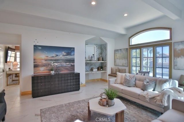 living room featuring beamed ceiling and a healthy amount of sunlight