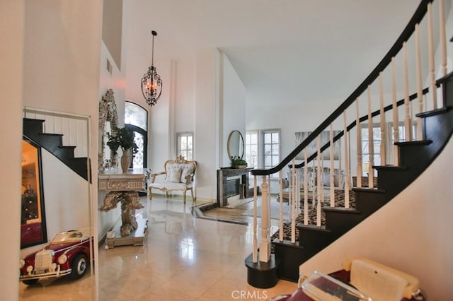 entrance foyer with a towering ceiling and an inviting chandelier