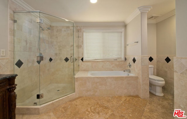 full bathroom featuring vanity, toilet, ornamental molding, and separate shower and tub