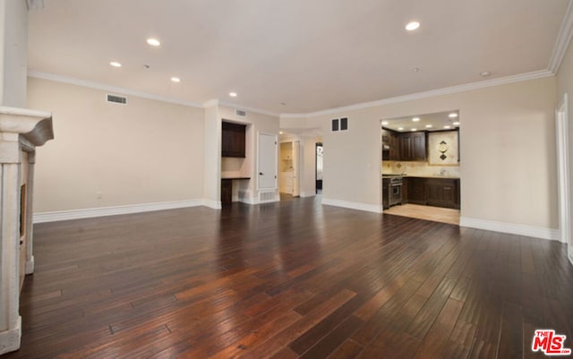 unfurnished living room featuring dark hardwood / wood-style floors and crown molding