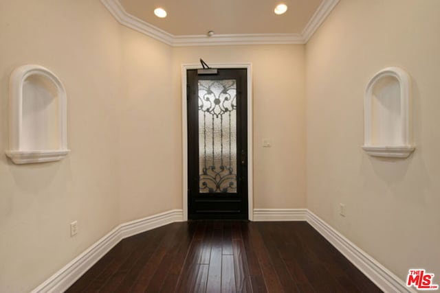 entrance foyer with dark hardwood / wood-style floors and crown molding