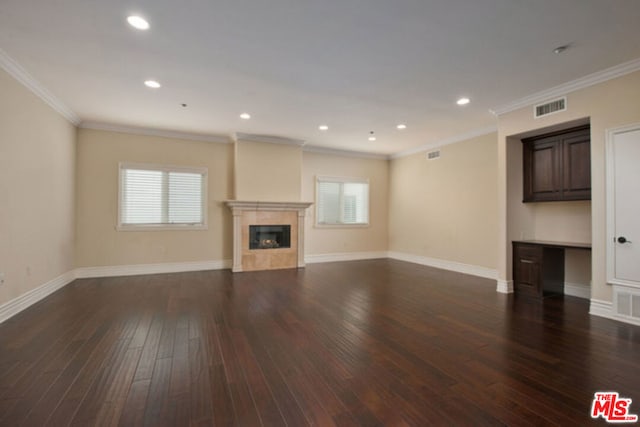 unfurnished living room featuring crown molding and dark wood-type flooring