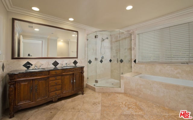 bathroom featuring vanity, independent shower and bath, and ornamental molding