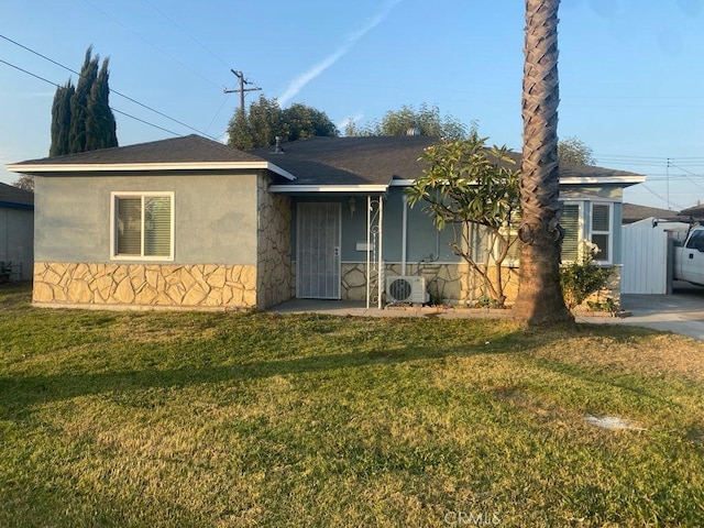 view of front of house featuring a front yard and ac unit