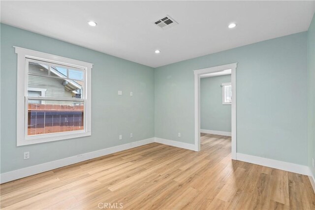 empty room with light hardwood / wood-style flooring