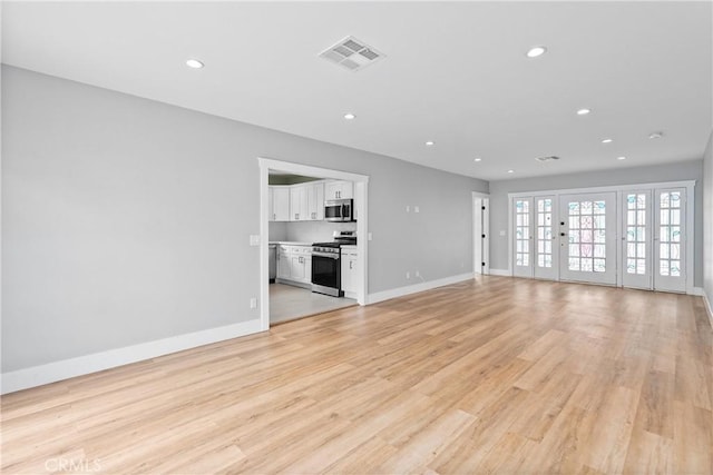 unfurnished living room featuring light wood-type flooring