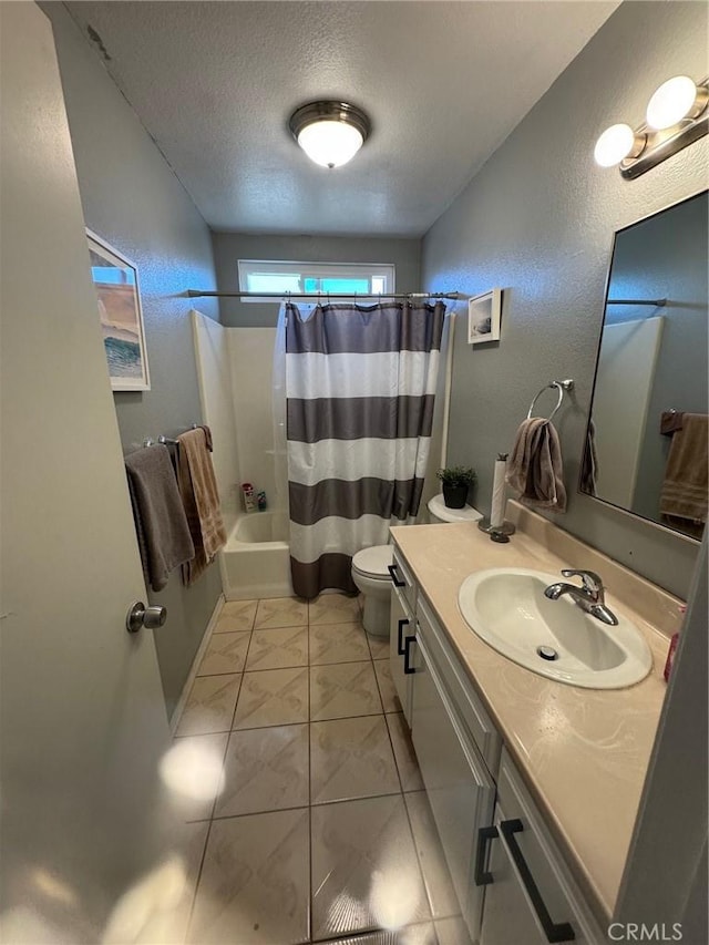 full bathroom with shower / bath combo, vanity, tile patterned floors, toilet, and a textured ceiling