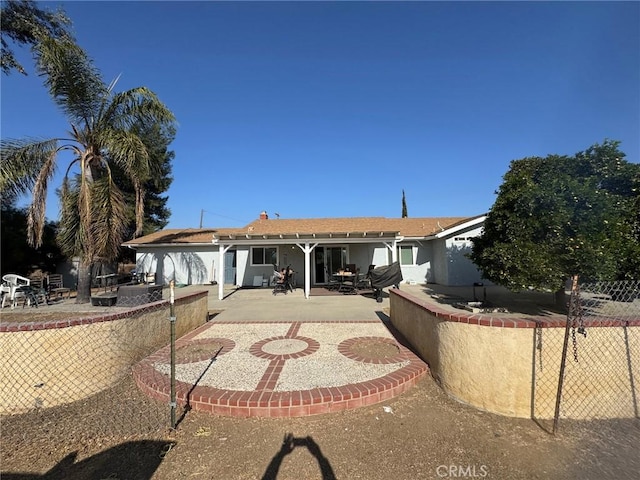 rear view of property featuring a patio area