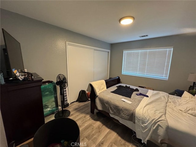 bedroom with a closet and light hardwood / wood-style floors