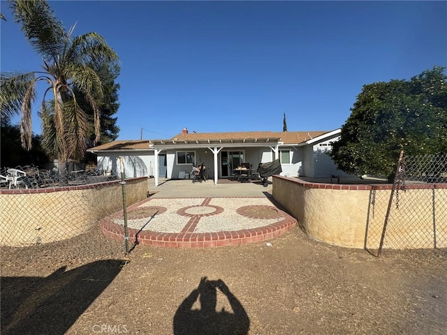 rear view of house featuring a patio