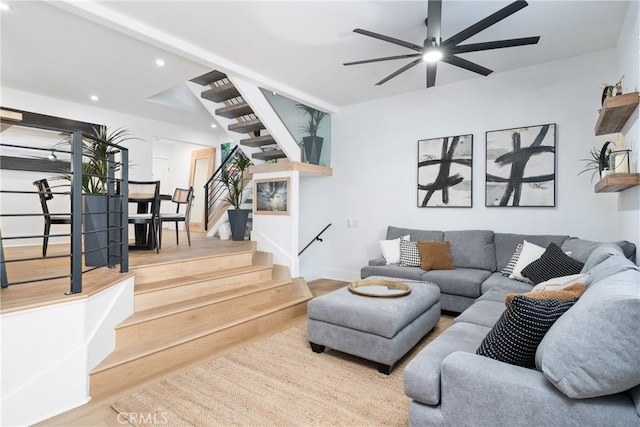 living room featuring hardwood / wood-style flooring and ceiling fan