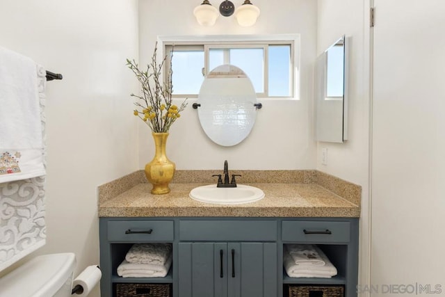 bathroom featuring vanity and toilet