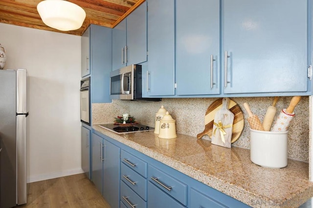 kitchen featuring light wood-type flooring, backsplash, stainless steel appliances, blue cabinets, and wooden ceiling