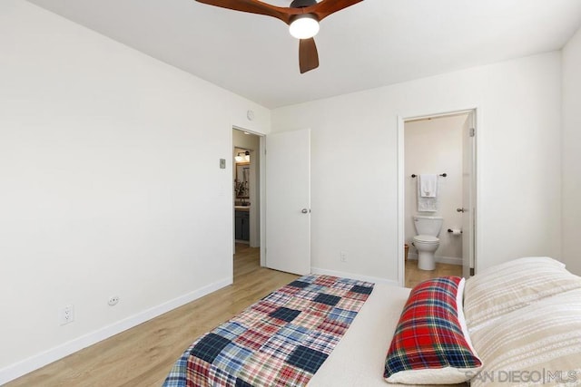 bedroom featuring ceiling fan, light hardwood / wood-style floors, and ensuite bath