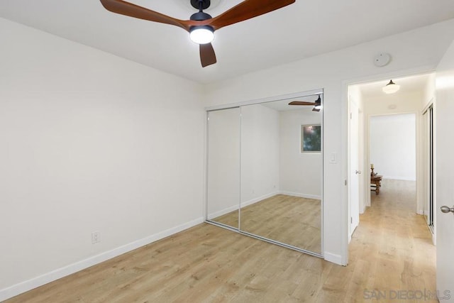 unfurnished bedroom with light wood-type flooring, a closet, and ceiling fan