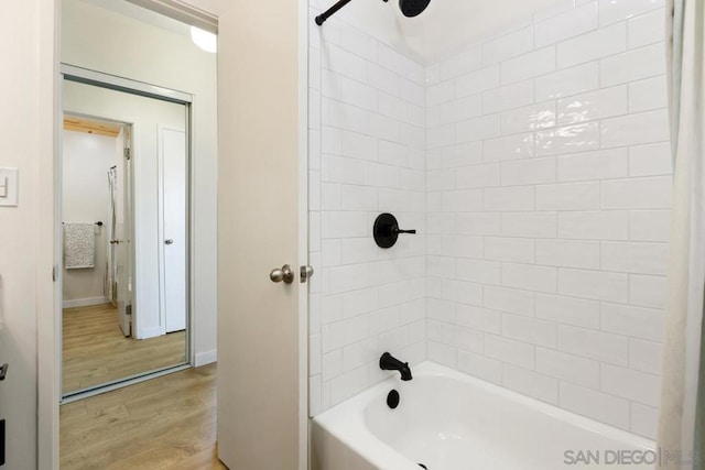 bathroom featuring shower / tub combo with curtain and wood-type flooring