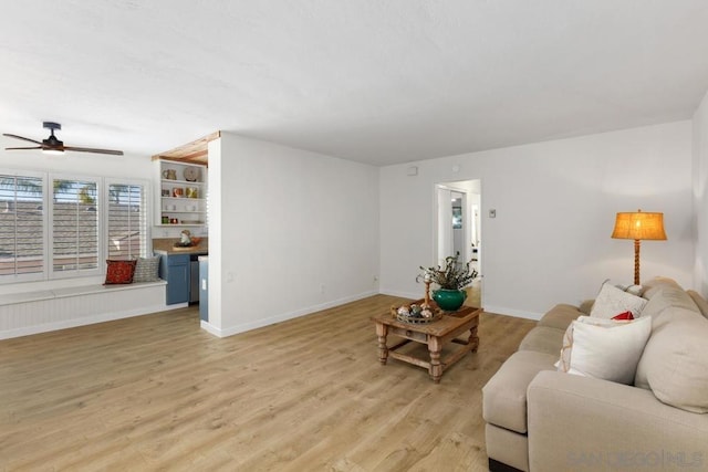 living room with light wood-type flooring and ceiling fan