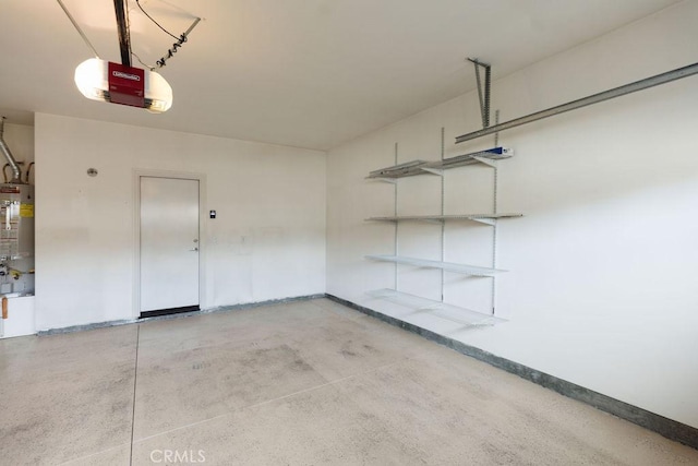 garage featuring baseboards, gas water heater, and a garage door opener