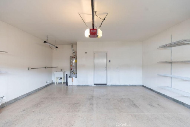 garage featuring a garage door opener, gas water heater, a sink, and baseboards