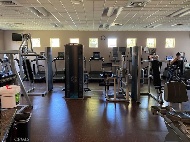 exercise room with a drop ceiling and visible vents