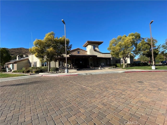 view of front of house featuring a tiled roof and stucco siding