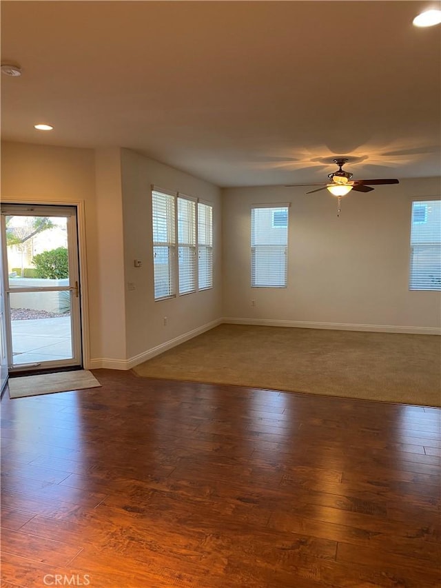 interior space with recessed lighting, ceiling fan, baseboards, and wood finished floors