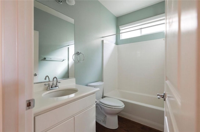 full bath with bathtub / shower combination, vanity, toilet, and wood finished floors