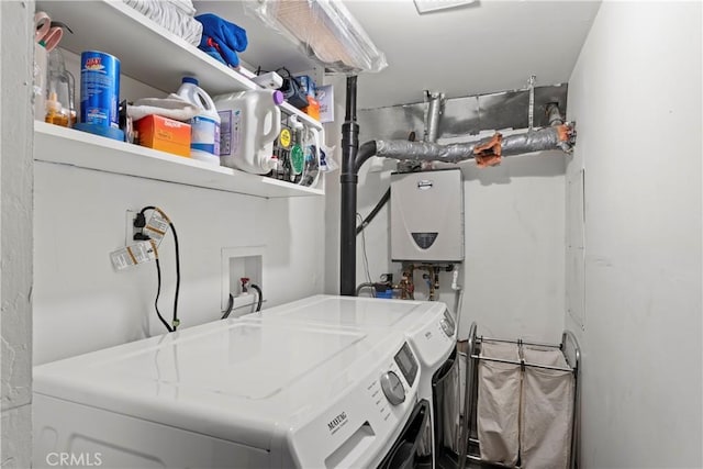 clothes washing area featuring tankless water heater and independent washer and dryer