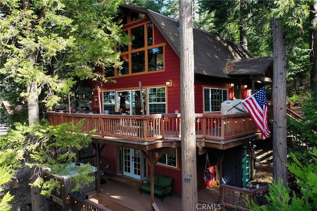 back of house with french doors and a deck