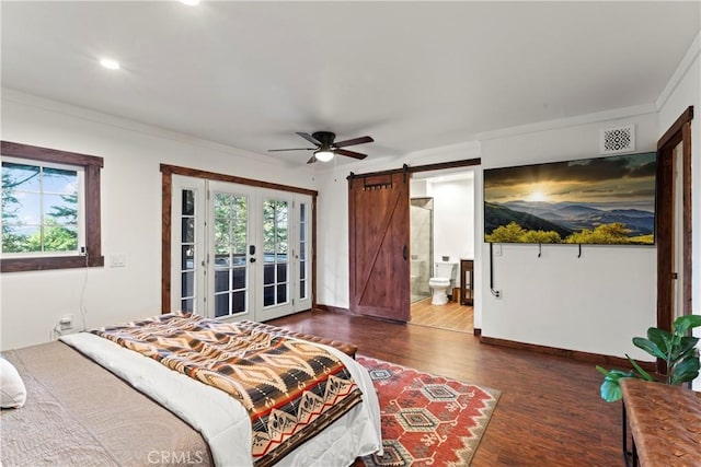 bedroom with ceiling fan, a barn door, dark wood-type flooring, and multiple windows