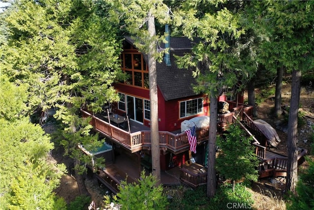 rear view of house featuring a wooden deck