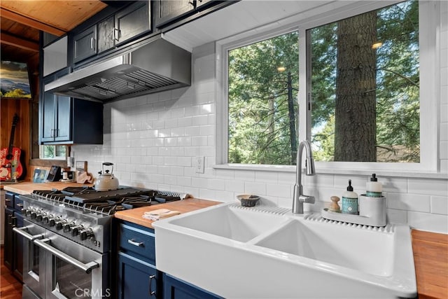 kitchen with backsplash, sink, double oven range, and wood counters