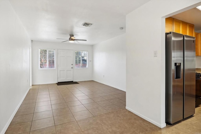 interior space featuring ceiling fan and light tile patterned floors