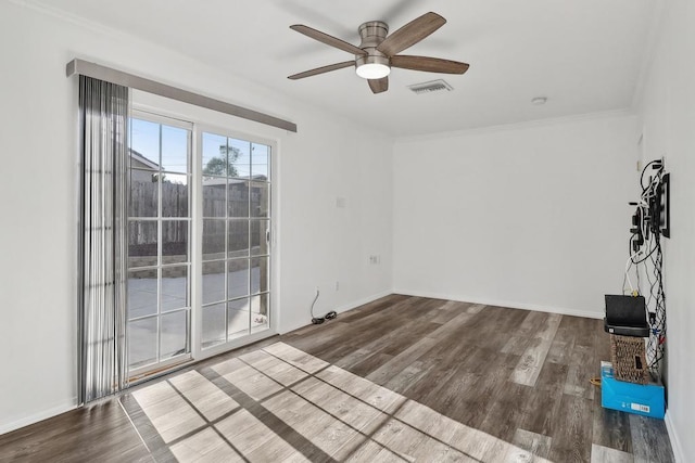 empty room featuring hardwood / wood-style flooring, ceiling fan, and ornamental molding