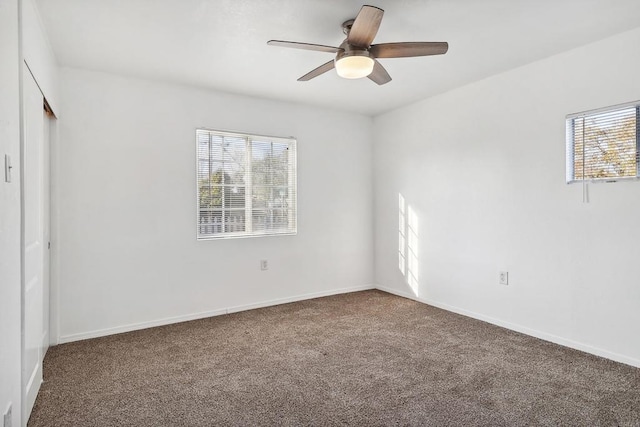 carpeted empty room with plenty of natural light and ceiling fan