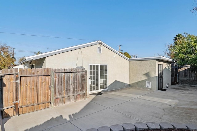 view of side of home with a patio