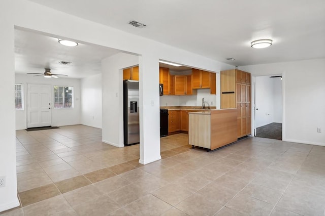 kitchen featuring ceiling fan, sink, stainless steel appliances, kitchen peninsula, and light tile patterned flooring