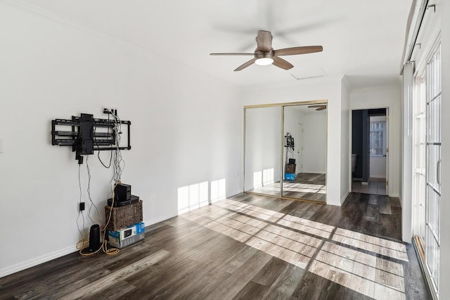 exercise area with ceiling fan and dark hardwood / wood-style flooring