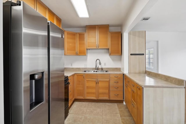 kitchen featuring black range with electric stovetop, stainless steel fridge, sink, and light tile patterned floors