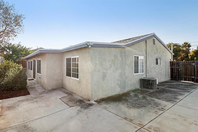 view of property exterior featuring a patio area and cooling unit