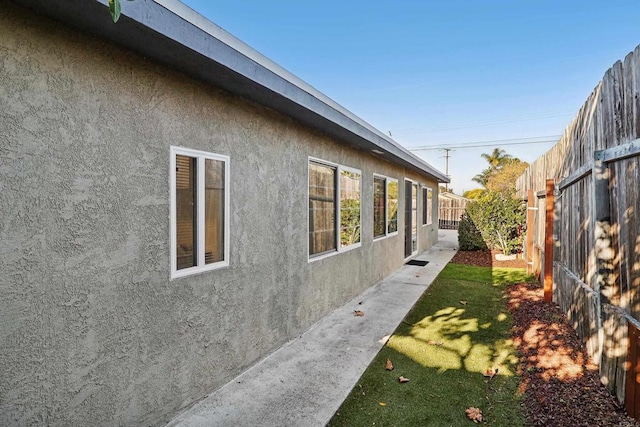 view of property exterior featuring a lawn