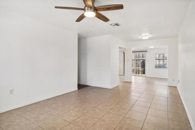 empty room with ceiling fan and light tile patterned floors