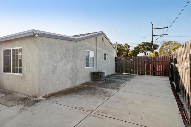 view of home's exterior with central air condition unit and a patio