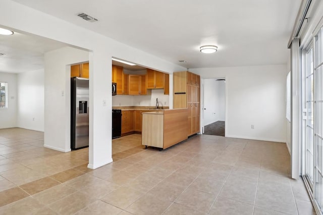 kitchen featuring light tile patterned floors, sink, and appliances with stainless steel finishes