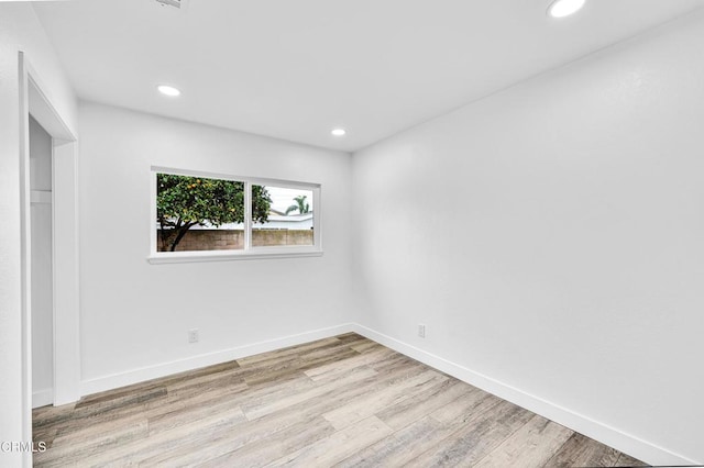 spare room featuring light hardwood / wood-style flooring