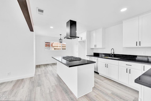 kitchen with island range hood, stainless steel appliances, sink, light hardwood / wood-style flooring, and white cabinets