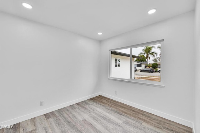 unfurnished room with hardwood / wood-style flooring