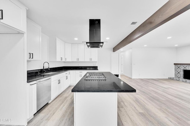 kitchen with light hardwood / wood-style floors, a kitchen island, stainless steel appliances, and ventilation hood