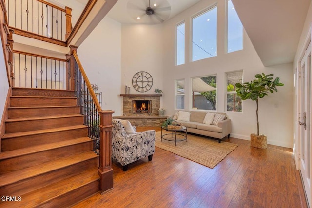 living room featuring hardwood / wood-style flooring, plenty of natural light, ceiling fan, and a fireplace